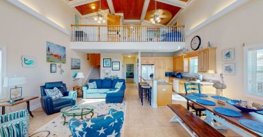 The lofty main floor living space seamlessly integrates the living, dining, and kitchen areas into a social hub, encouraging and promoting quality time with loved ones.